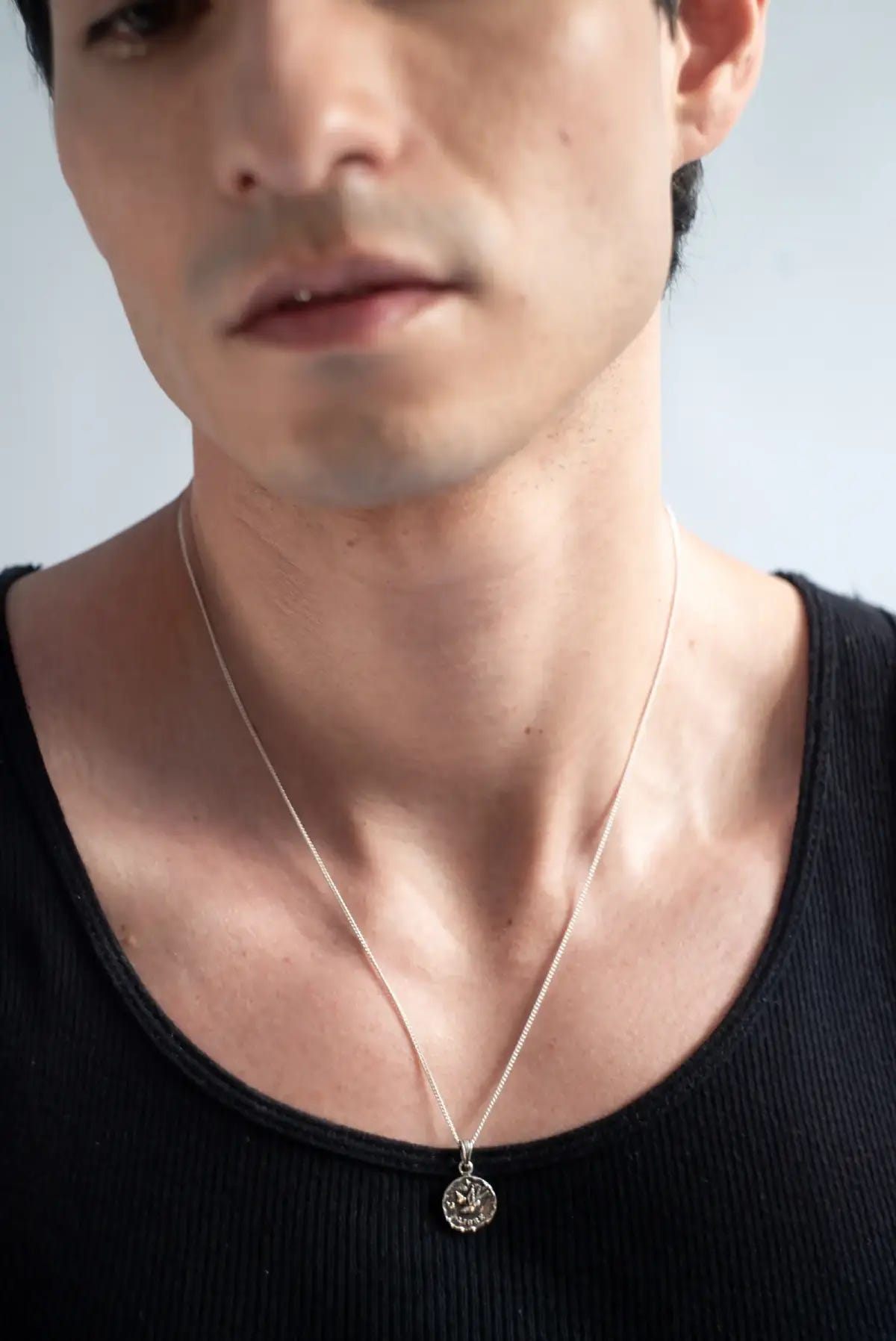 Collar Libre Icon visto de cerca, detalle de la medalla en plata .950